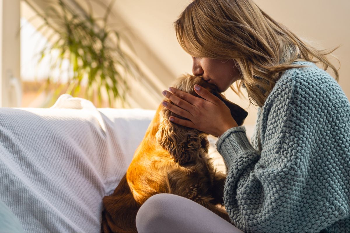 women-kissing-dog's-head